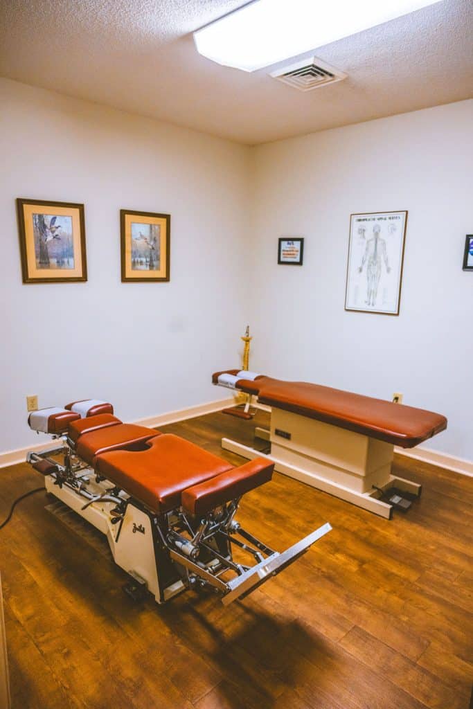 Chiropractic treatment room with adjustment tables at a chiropractor in Opelika, AL, offering expert care and services.