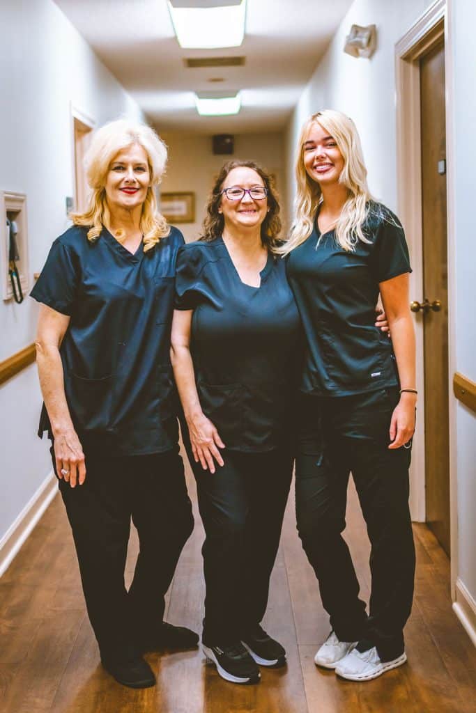 Chiropractic team in Opelika, AL standing together, providing professional care in a welcoming environment.