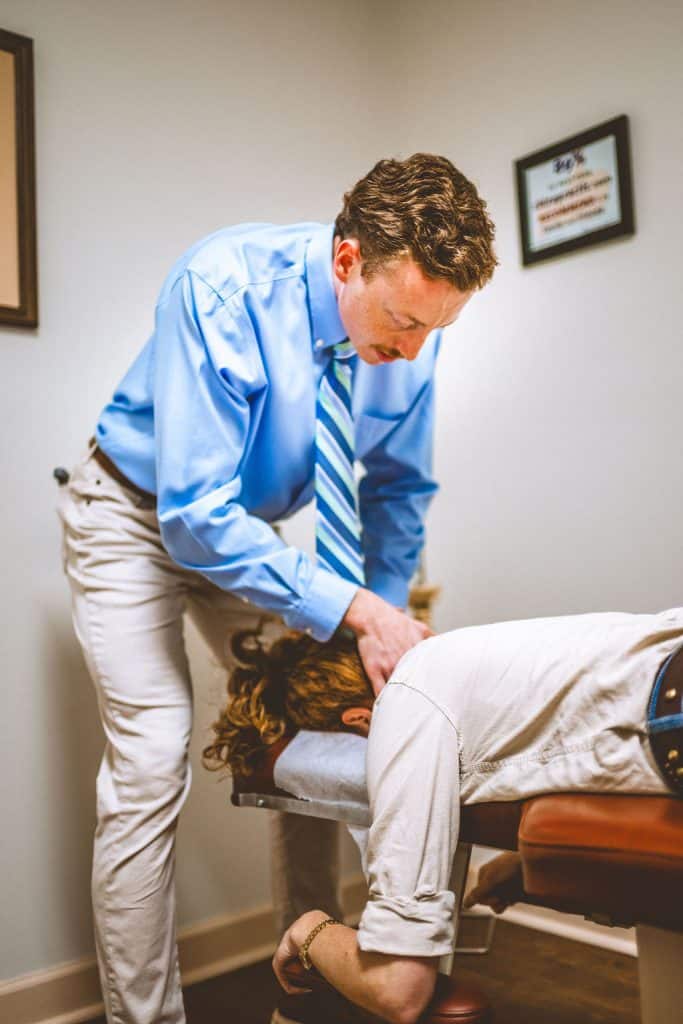 Chiropractor in Opelika, AL performing a neck adjustment. Professional care for back and neck pain relief.